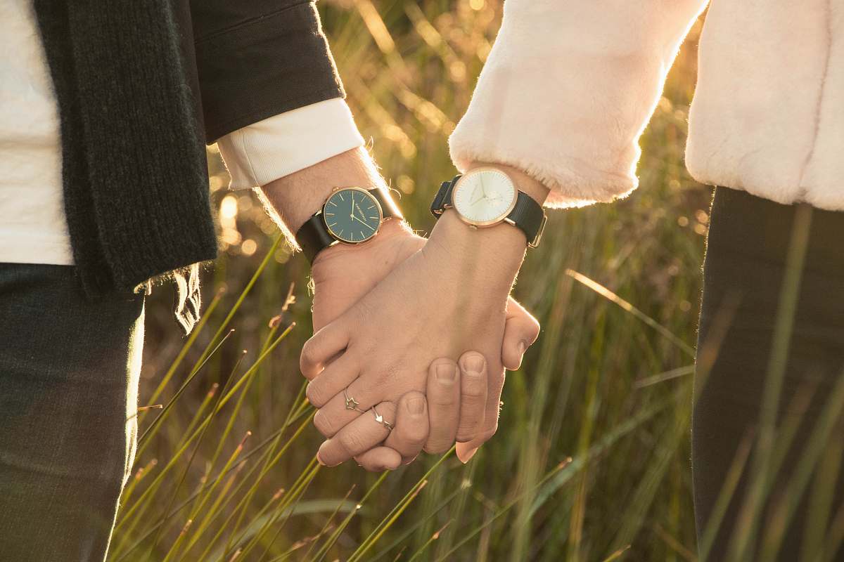 holding hands woman and man hand holding watch